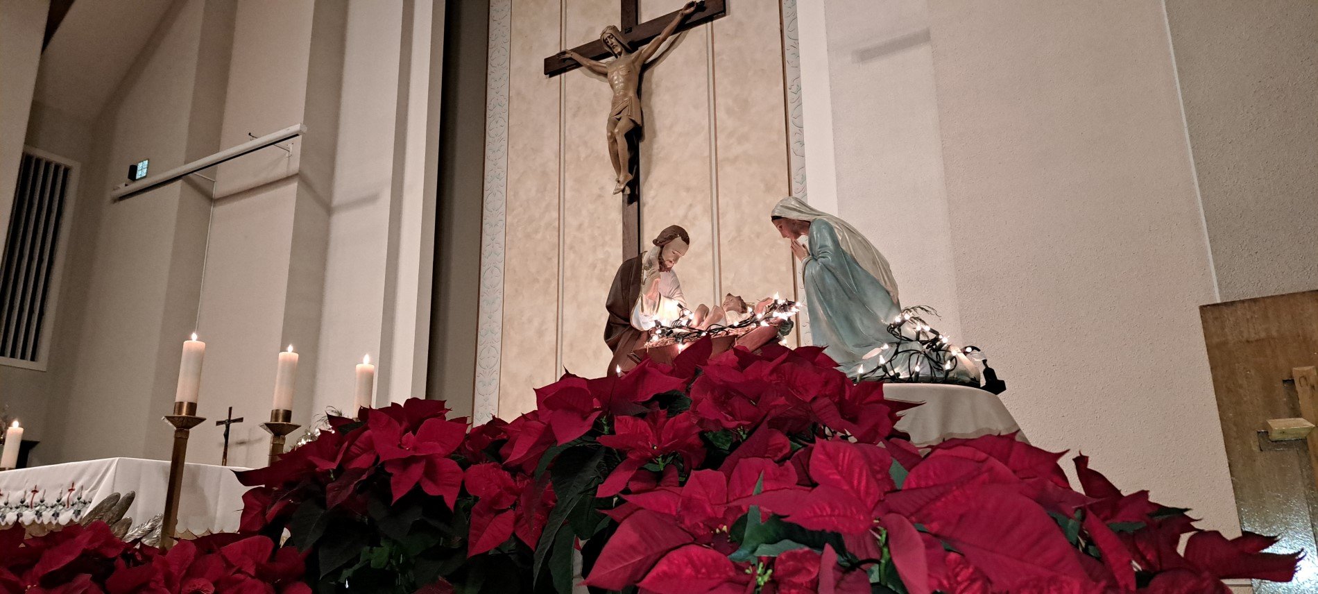 Picture of Nativity on altar as foreground to big crucifix