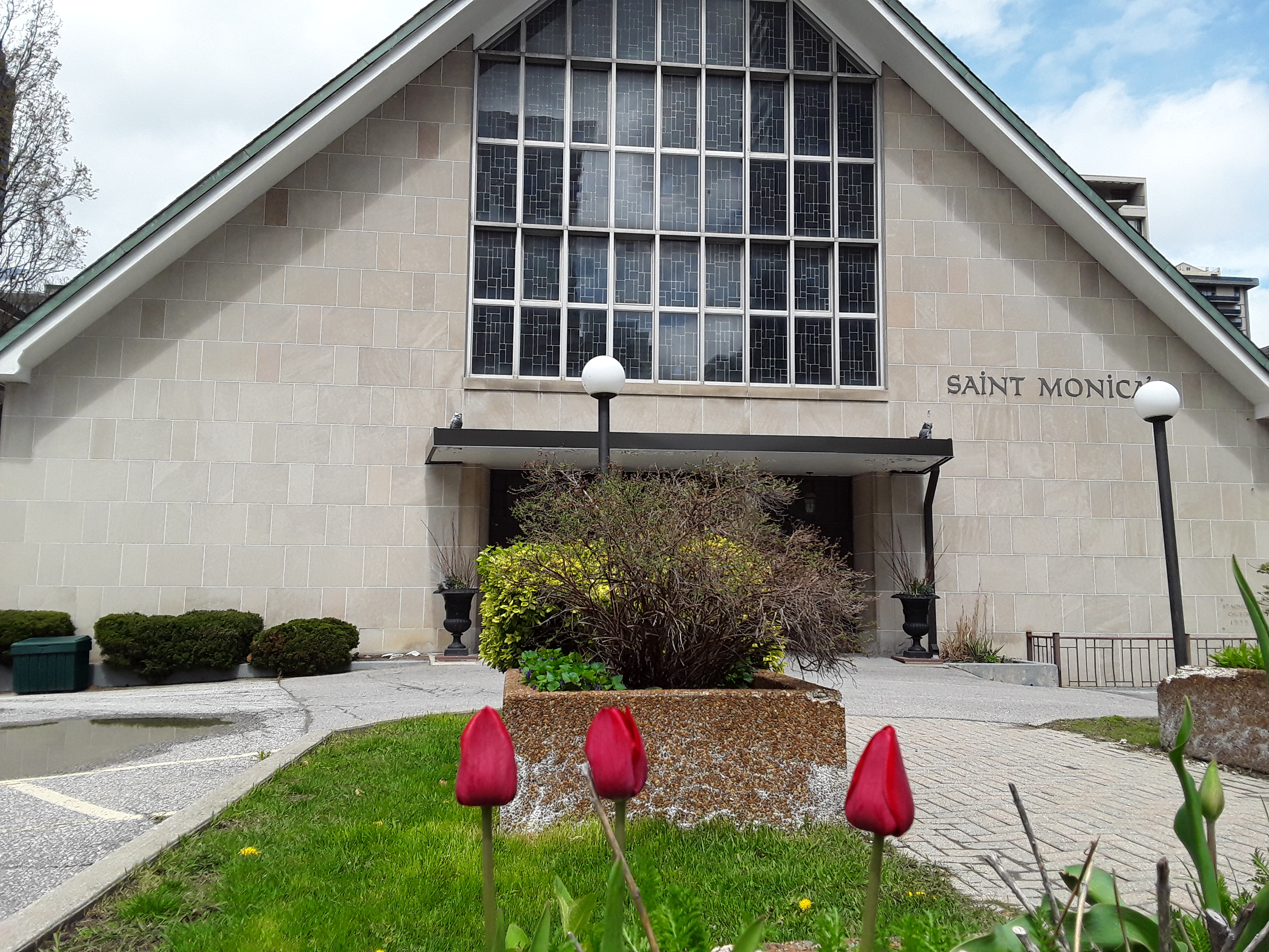 Picture of church building with red tulips in foreground