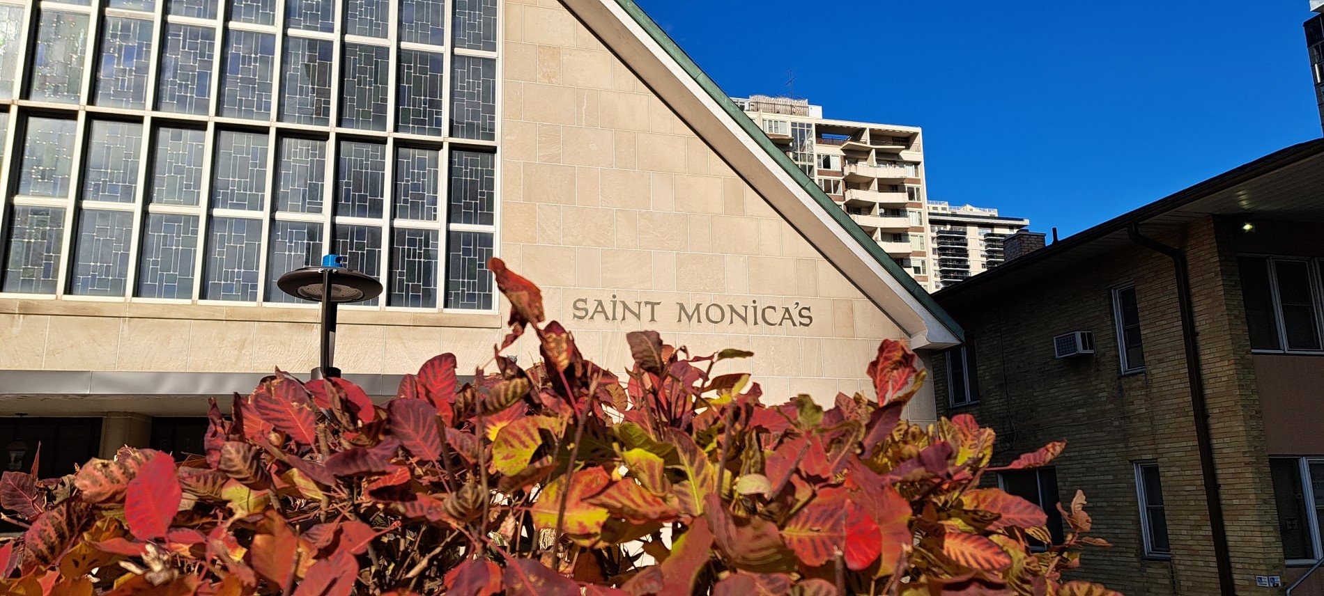 Picture of front of church with bush changing to Fall colors in foreground