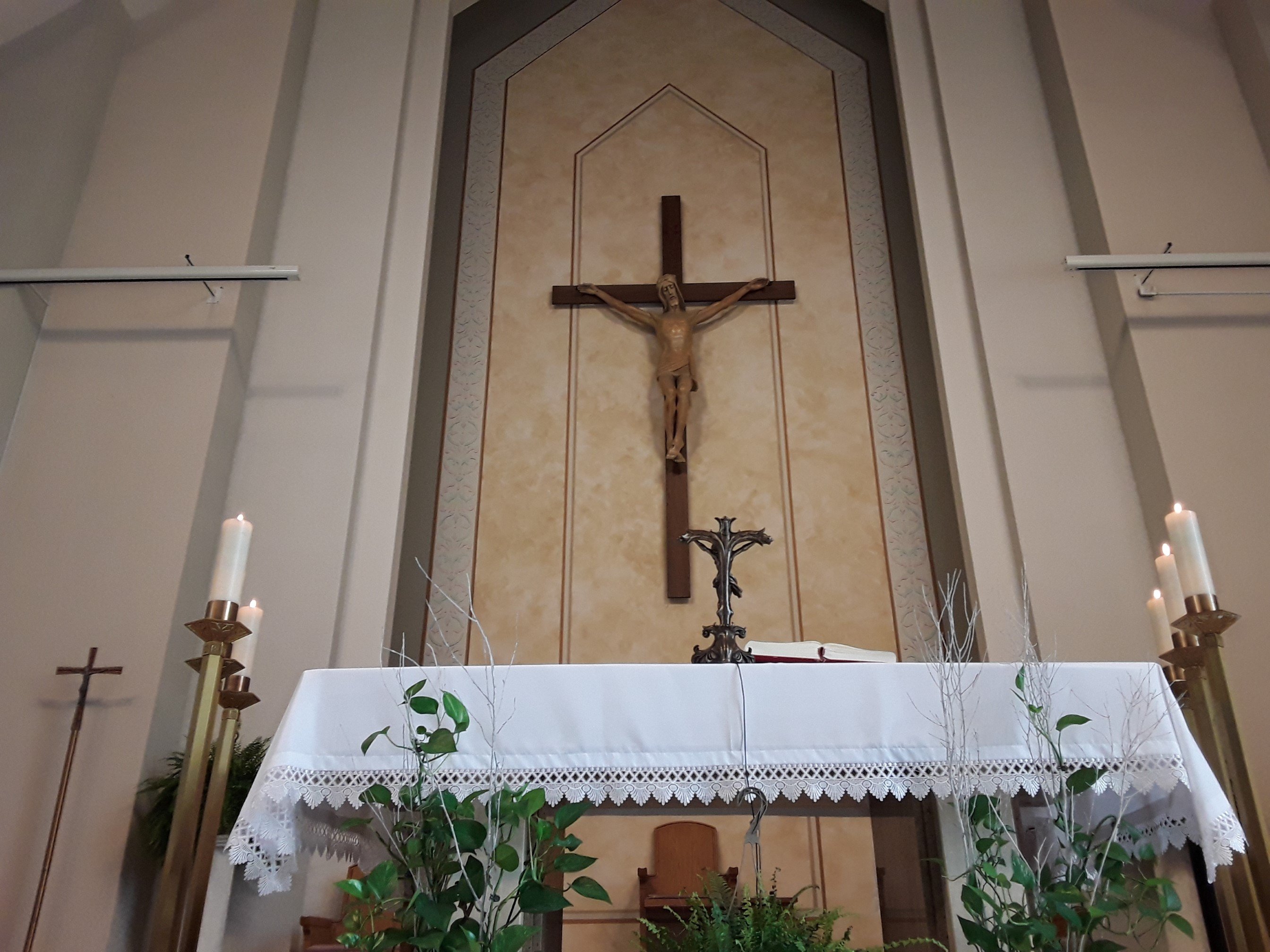 Picture of altar with big crucifix in background