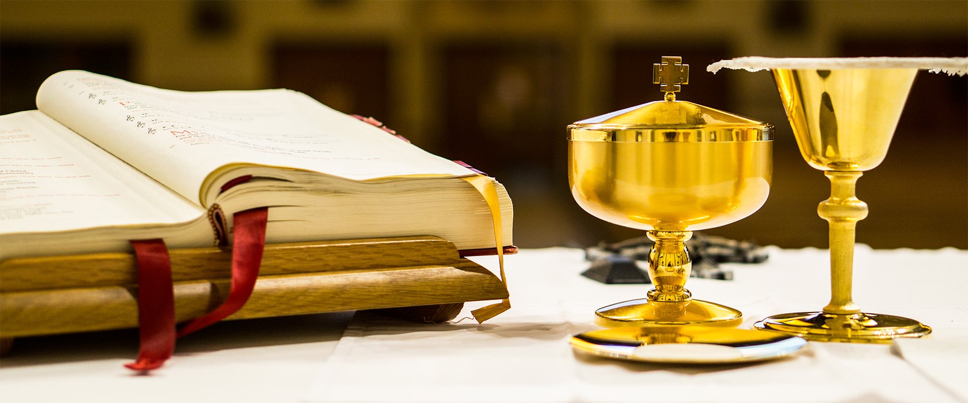 Closeup of Lectionary, Chalice and Ciborium on altar