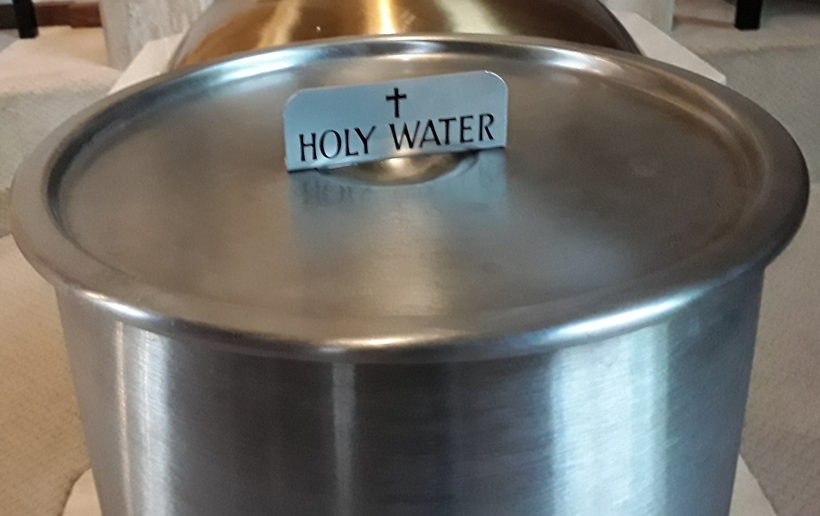 Stainless steel container of holy water