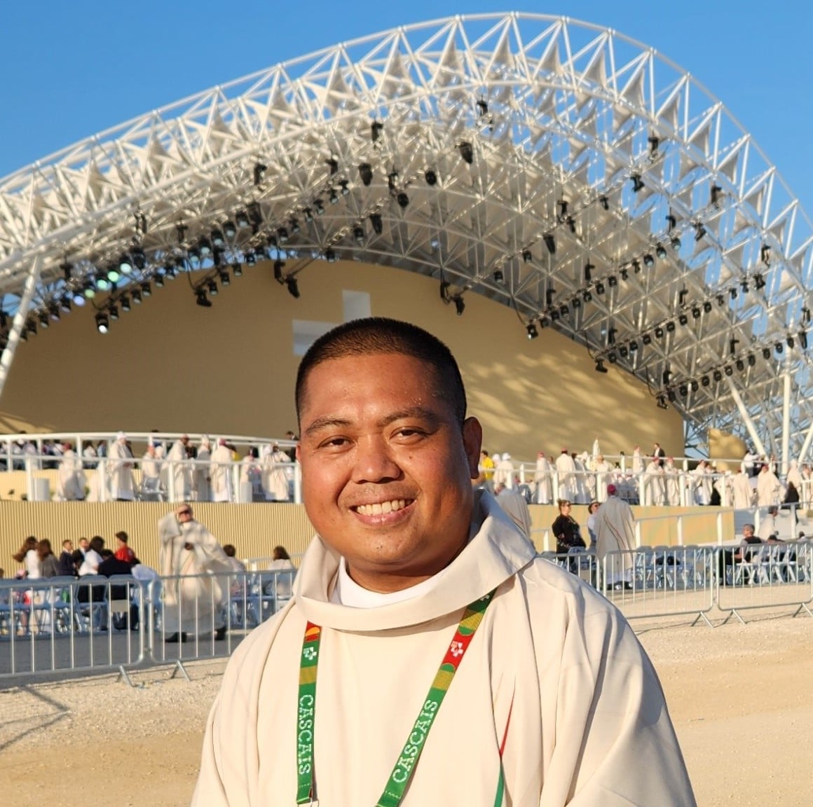 Picture of Fr. Joseph Baal in front of a stadium