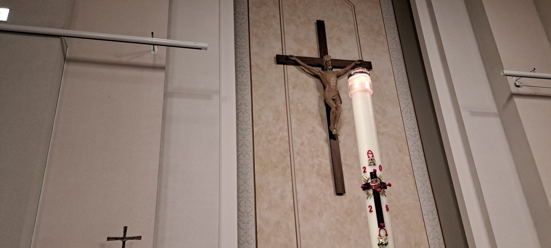 Picture of Easter candle with big crucifix in background