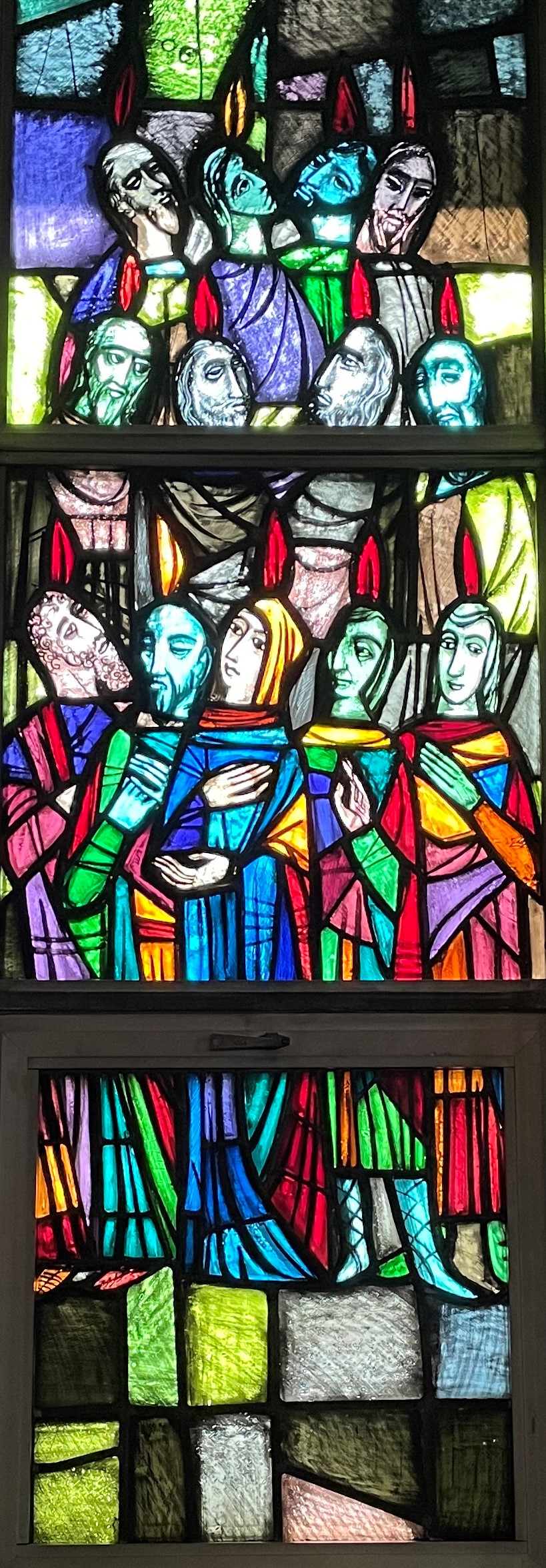 Picture of stained glass window showing the Holy Spirit as tongues of fire on 12 apostles