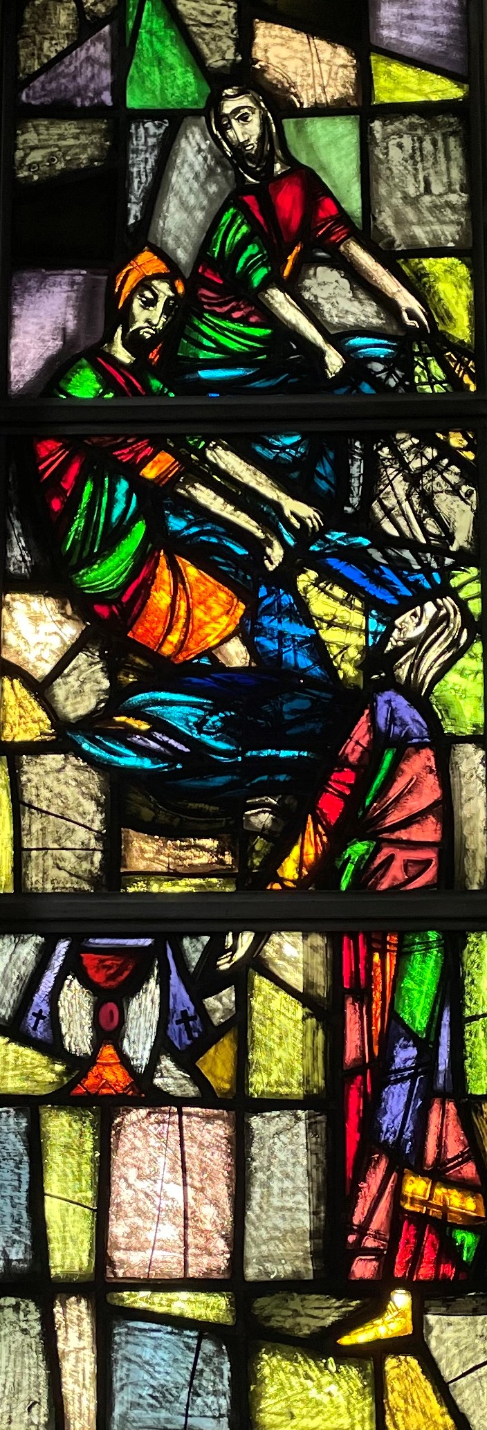Picture of stained glass window showing the apostles hauling their nets full of fish