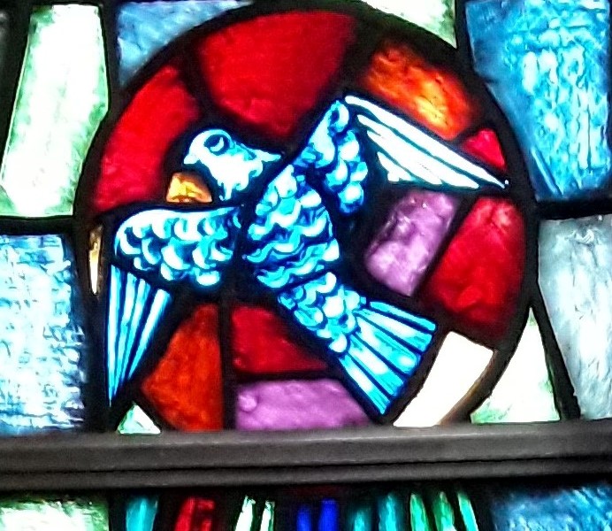 Stained glass of dove representing the Holy Spirit