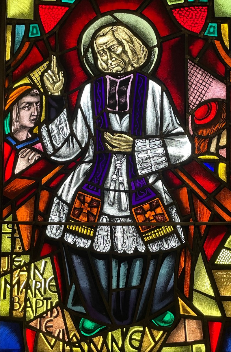 Stained glass window in sacristy showing image of St. Jean Marie Baptiste Vianney
