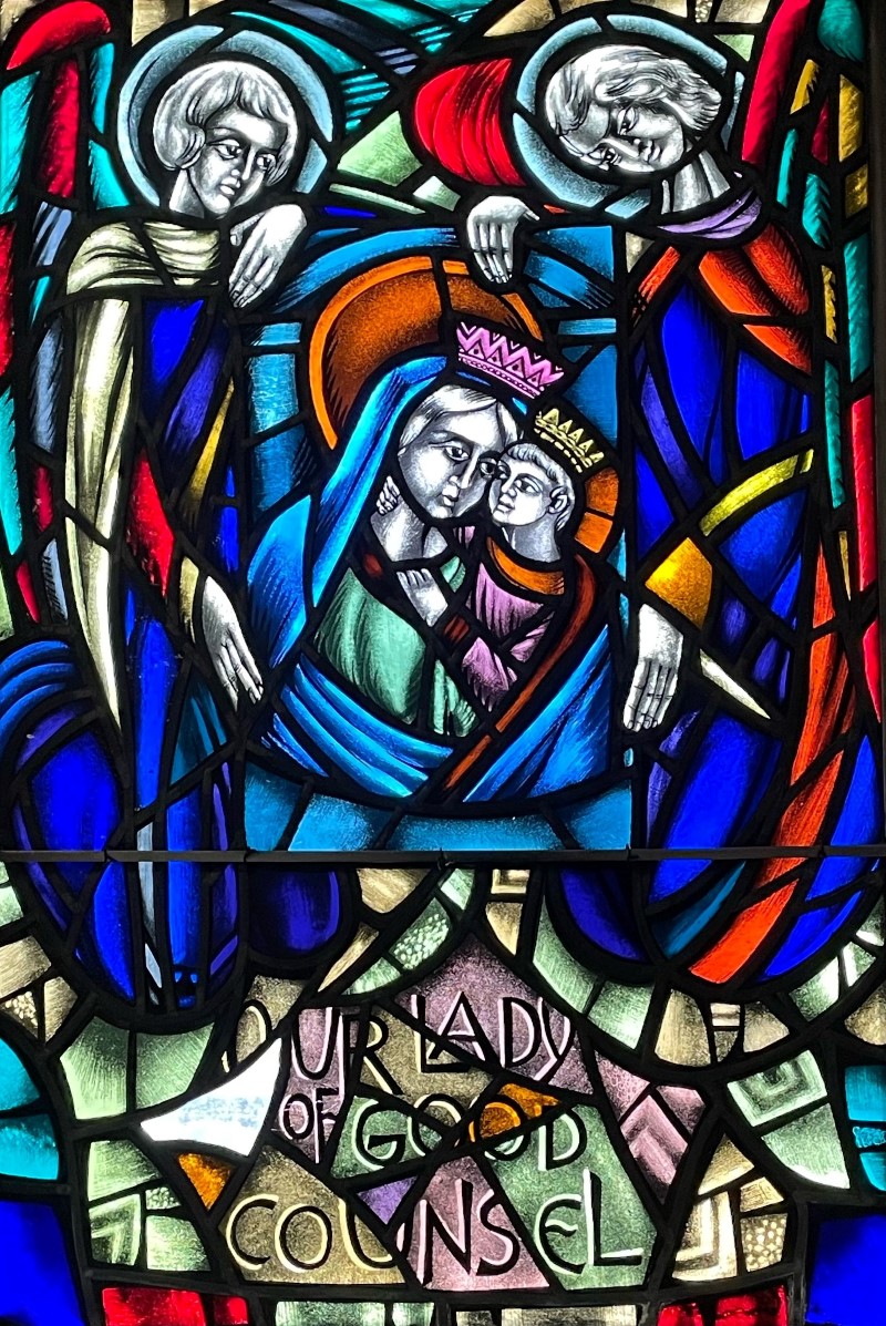 Stained glass window in sacristy showing image of Our Lady of Good Counsel