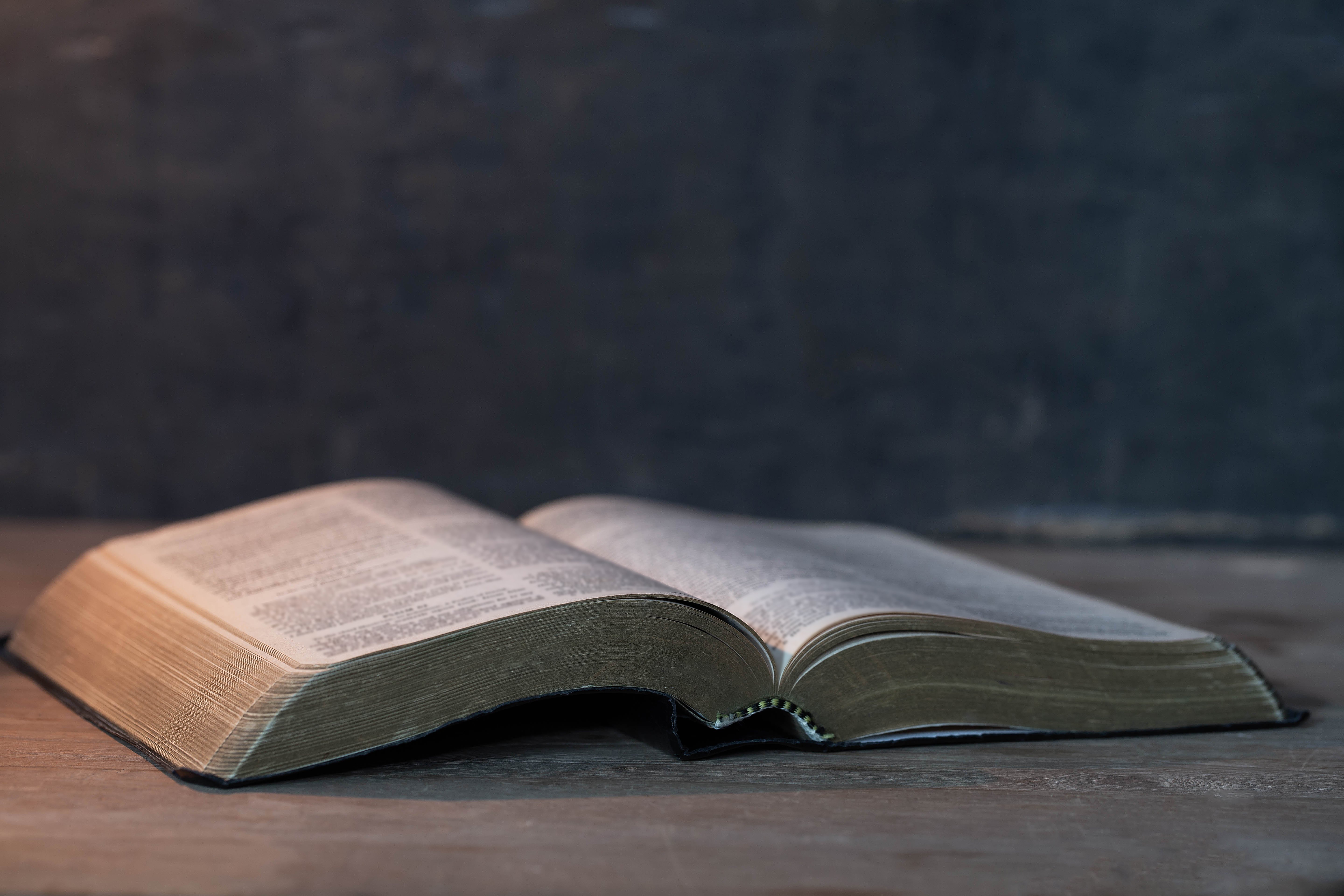 Picture of an open Bible on a wooden table