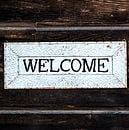 A photo of a sign that says "Welcome"